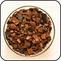 Chopped maritime pine bark in a glass dish